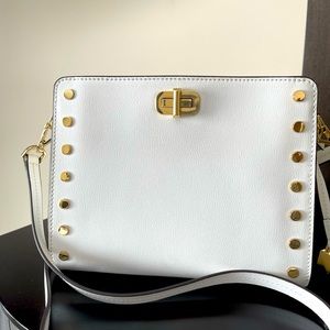Michael Kors white leather crossbody bag with gold hardware.